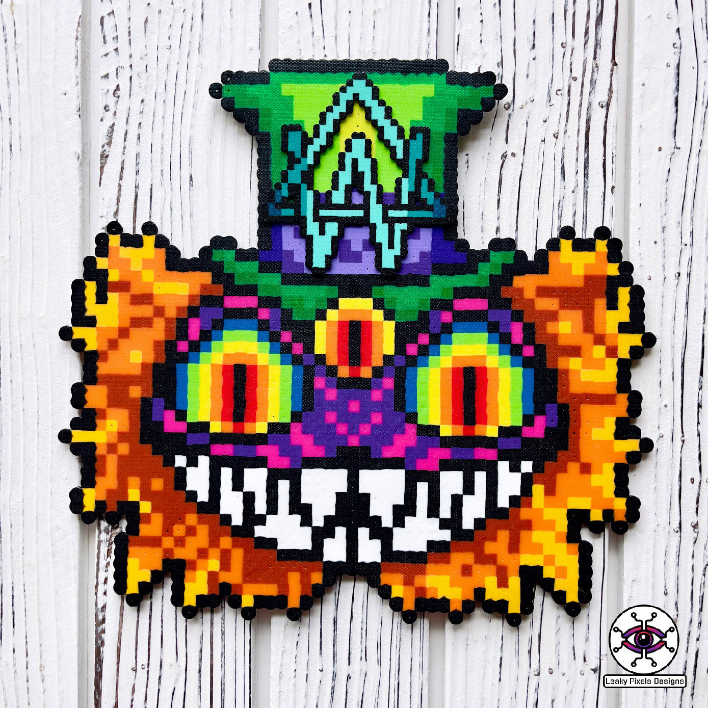 Alison Wonderland mad hatter perler necklaced by leaky pixels. Cheshire cat eyes and mouth with a third eye. Alison Wonderland logo on top hat.