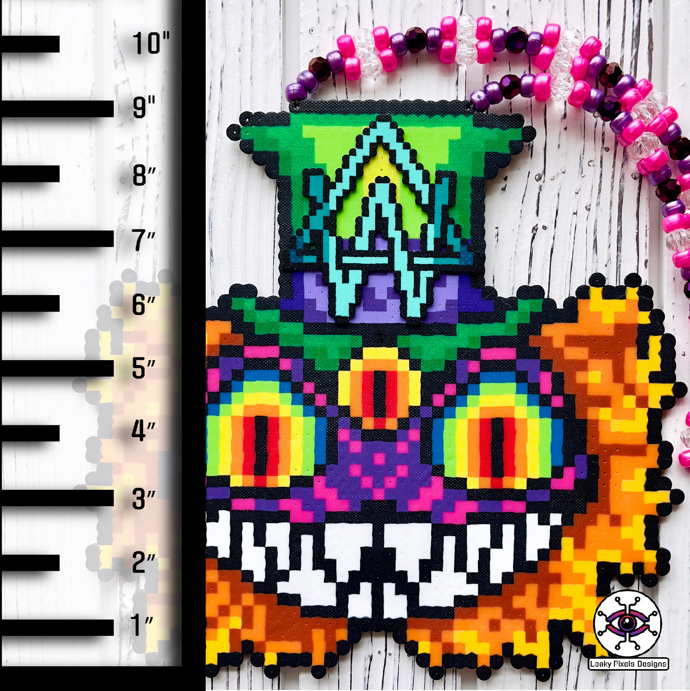 Alison Wonderland mad hatter perler necklaced by leaky pixels. Cheshire cat eyes and mouth with a third eye. Alison Wonderland logo on top hat.