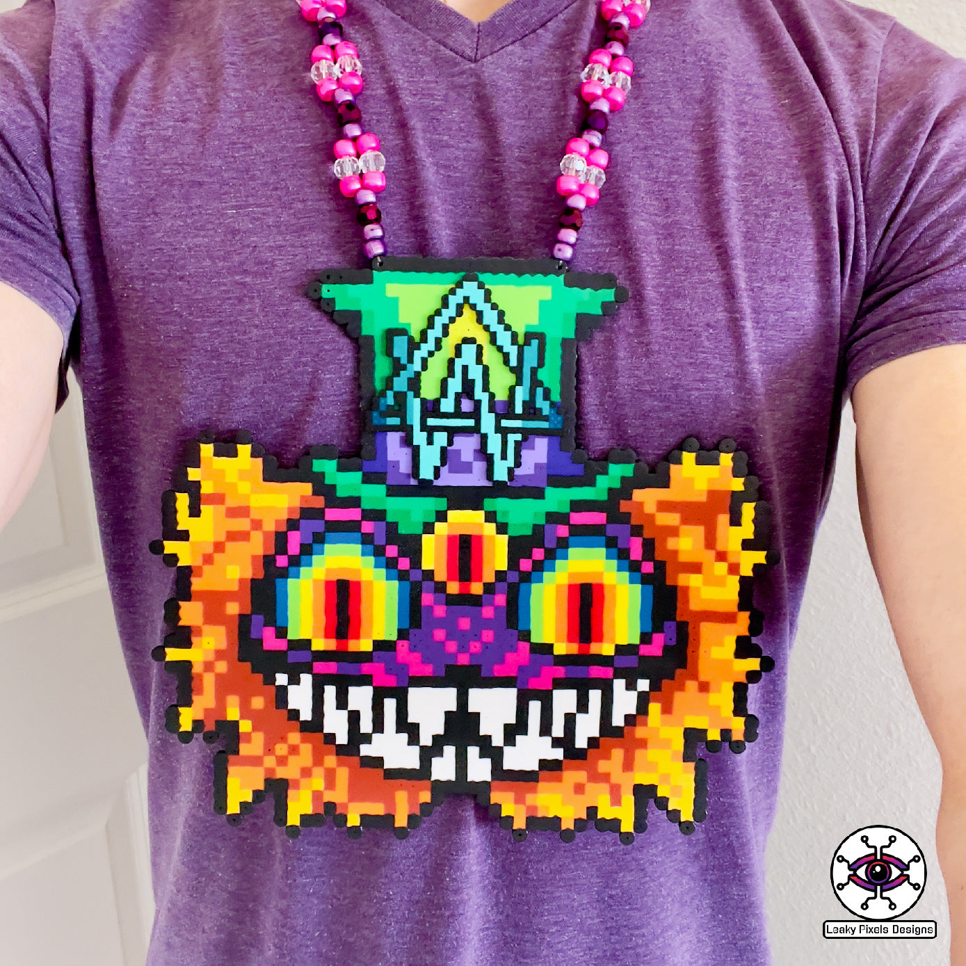 Alison Wonderland mad hatter perler necklaced by leaky pixels. Cheshire cat eyes and mouth with a third eye. Alison Wonderland logo on top hat.