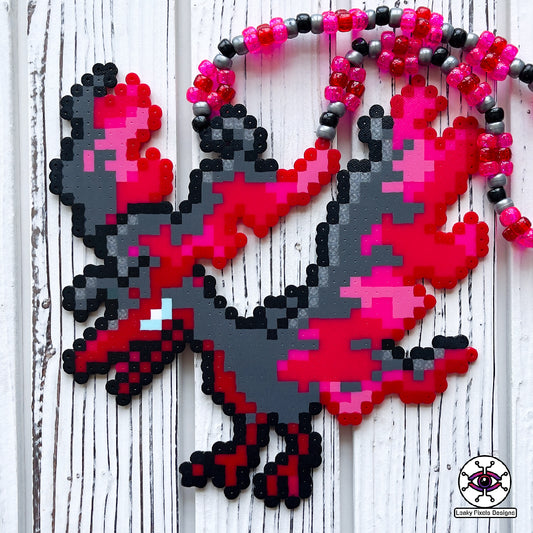 galarian moltres pokemon perler necklace made by leaky pixles. megenta, pink and red legendary bird with fire wings. dark grey body.pink and red glitter pony beads make up the necklace.