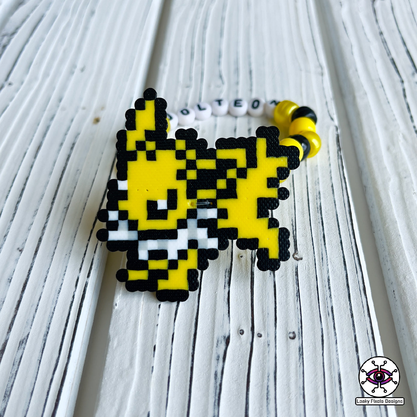 Eeevee pokemon evolutions perler bracelets. Vaporeon, Jolteon, Flareon, Espeon, Umbreon, Leafeon, Glaceon, and Sylveon by leaky pixels.