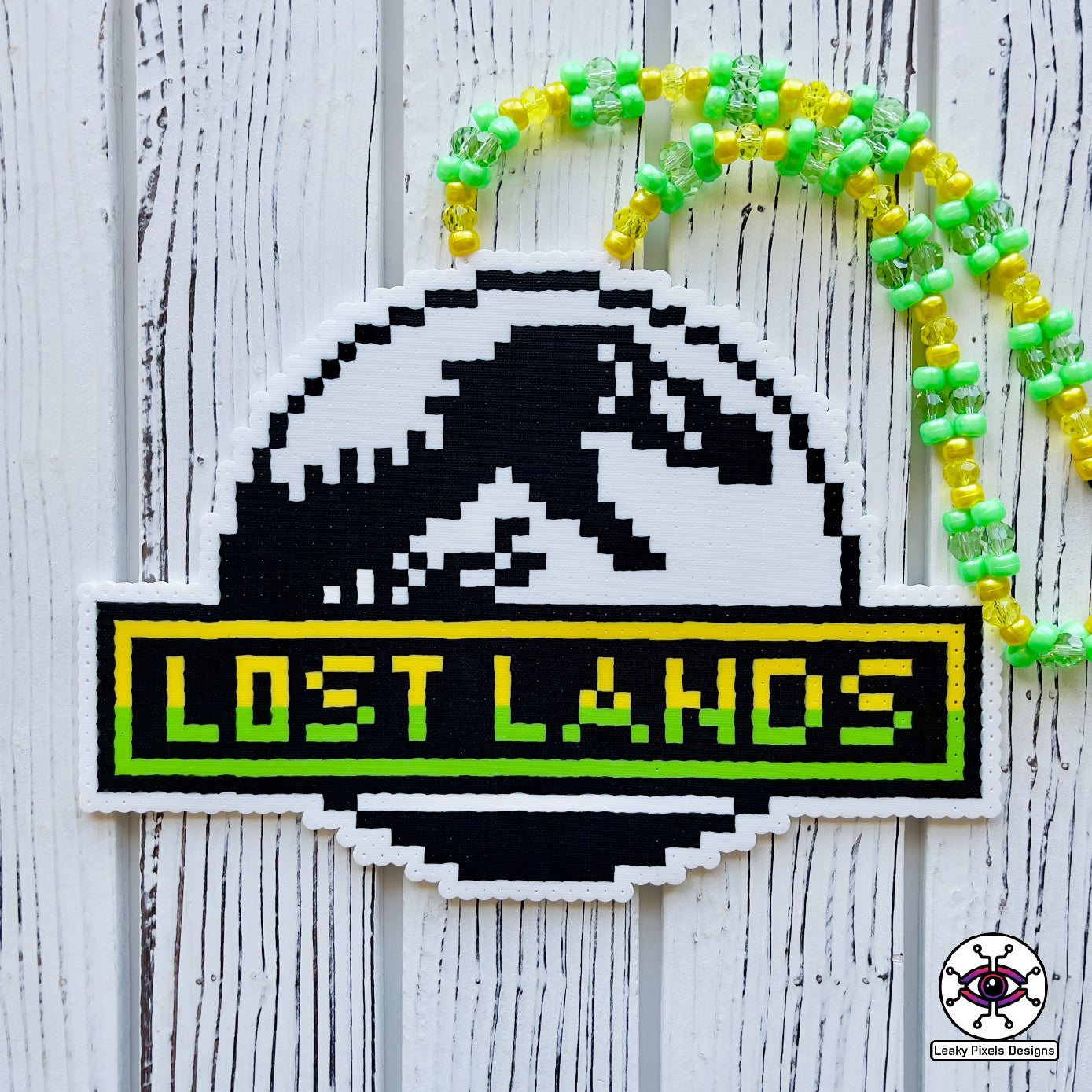 lost lands perler necklace excision by leaky pixels. has a jurassic park like trex