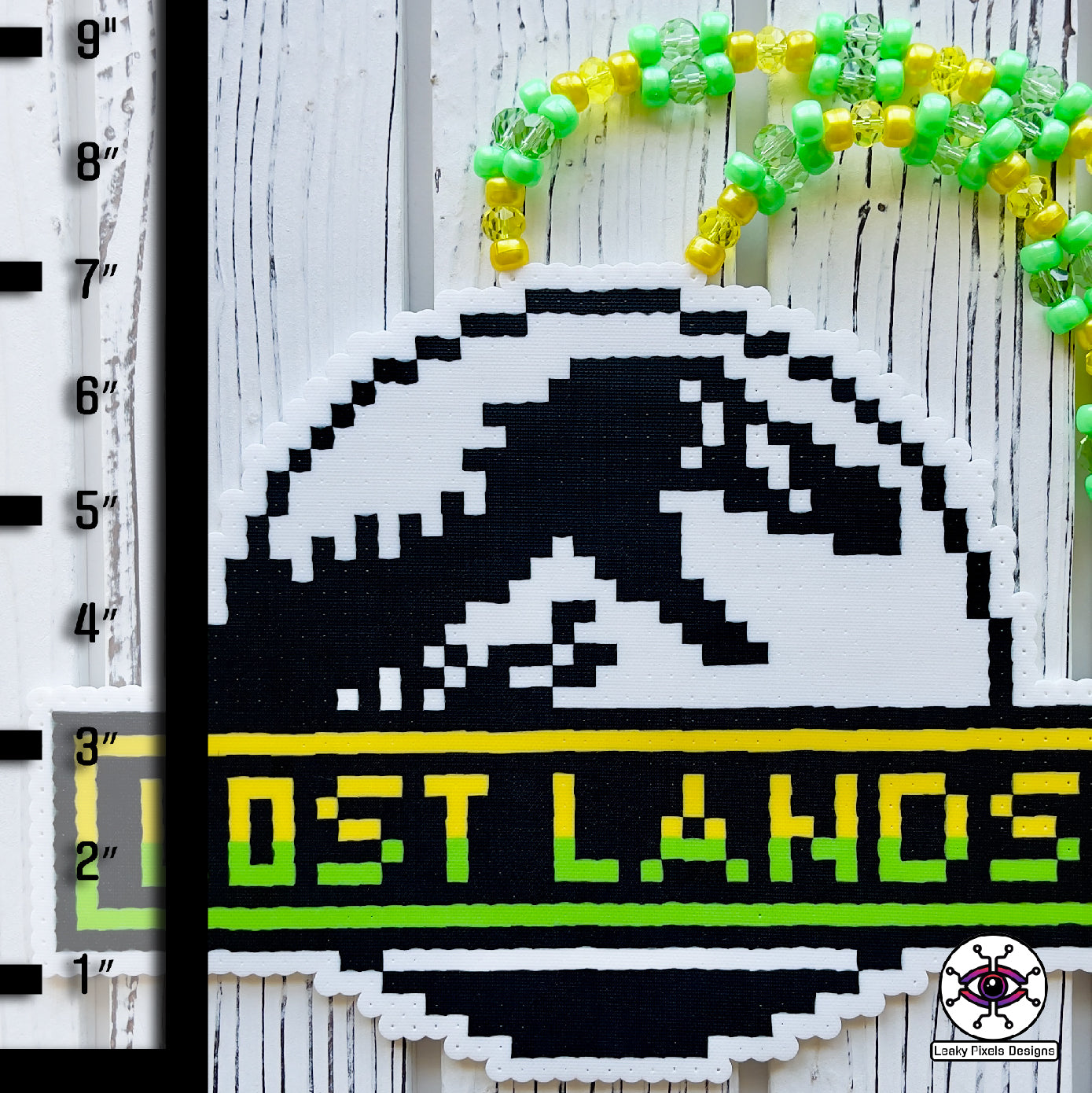 lost lands perler necklace excision by leaky pixels. has a jurassic park like trex
