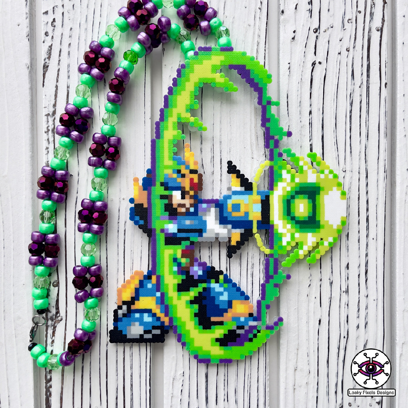 mega man x4 perler necklace by leaky pixels. shooting his x buster in a big green blast wave.