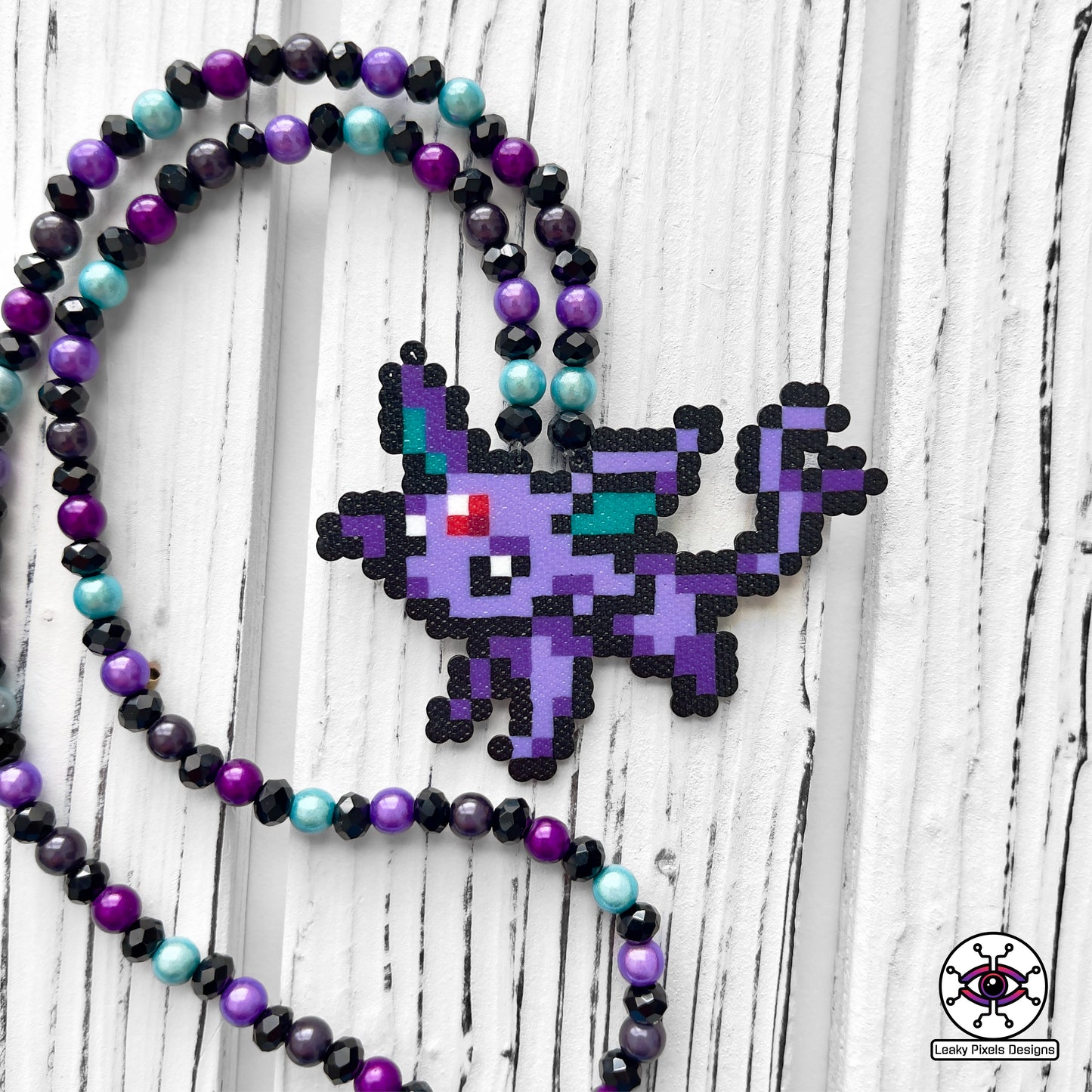 Mini espeon pokemon perler necklace made by leaky pixels.
