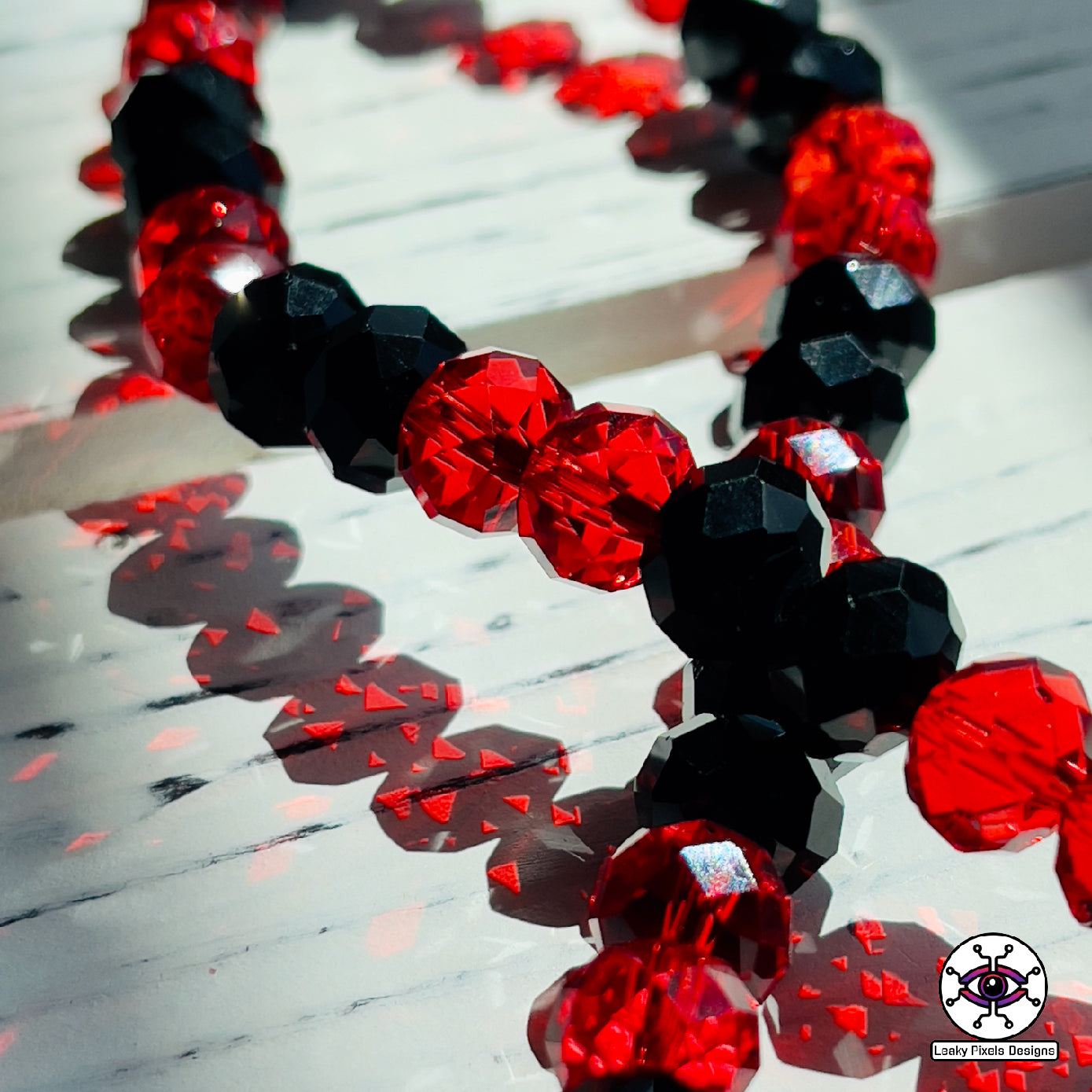 Sullivan king perler necklace by leaky pixels. red and black letters with red and black glass crystal beads