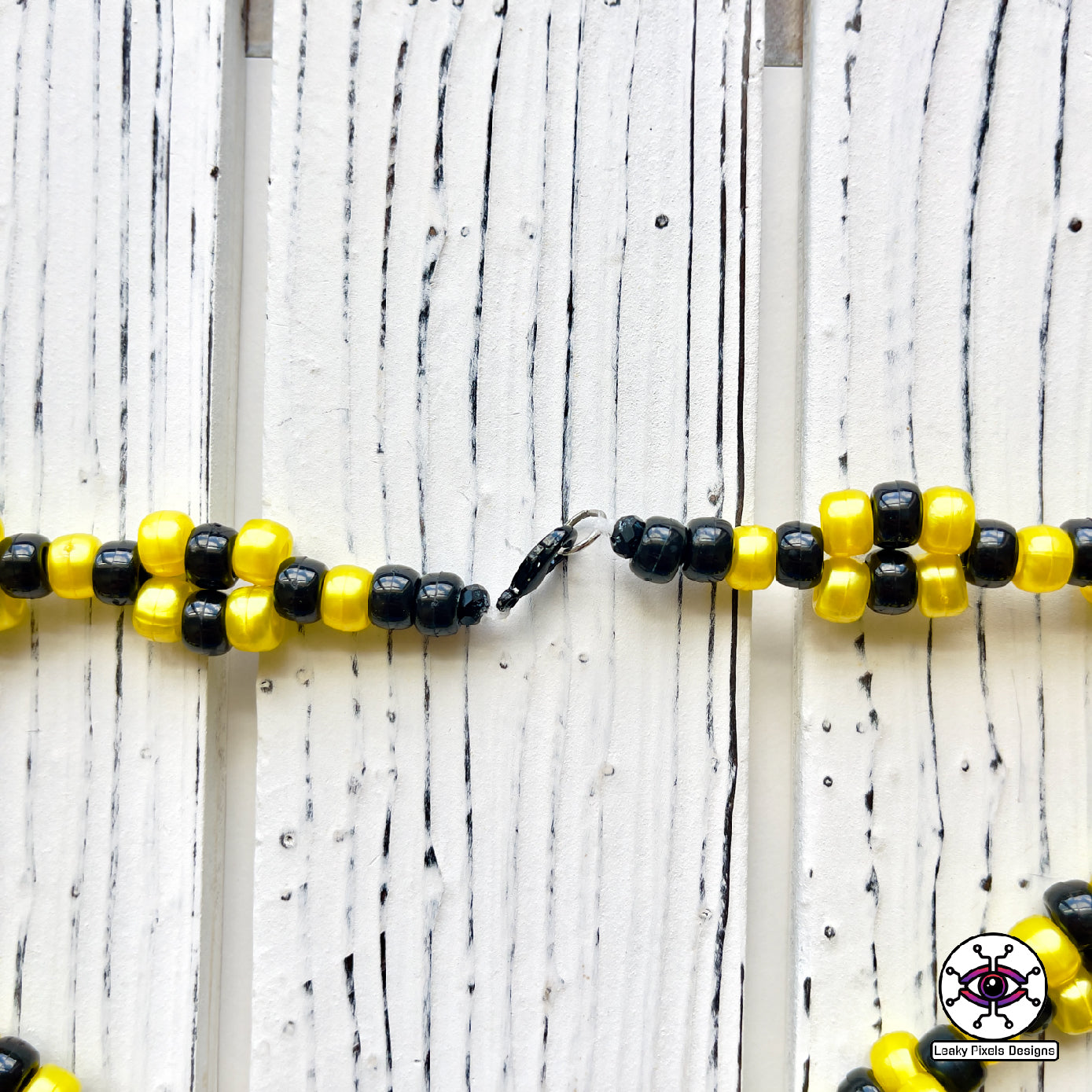 Umbreon pokemon Perler necklace black, with gold rings and red eyes