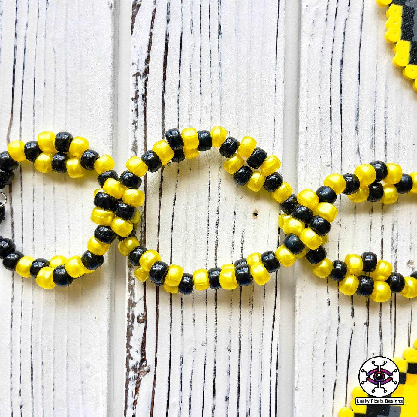 Umbreon pokemon Perler necklace black, with gold rings and red eyes