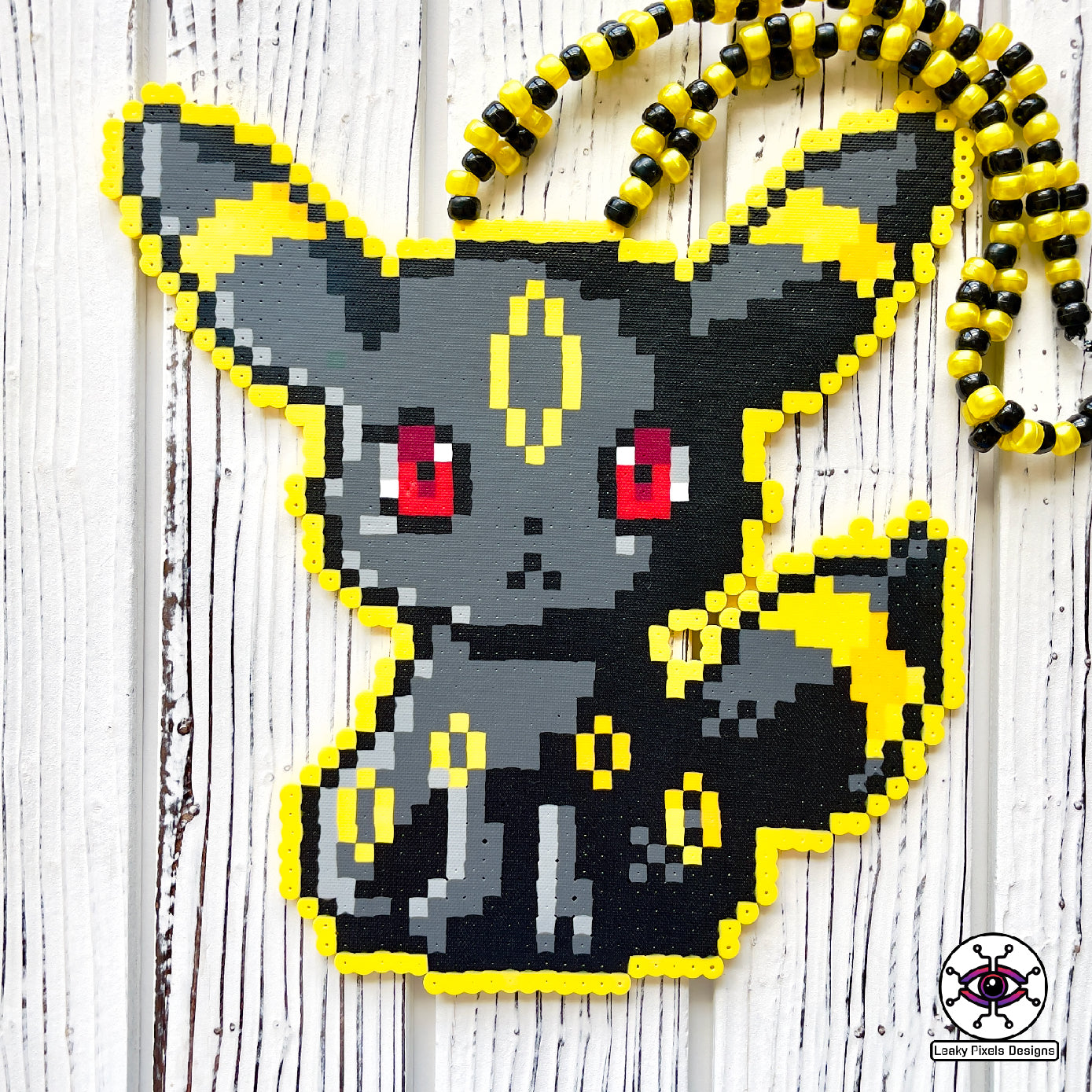Umbreon pokemon Perler necklace black, with gold rings and red eyes