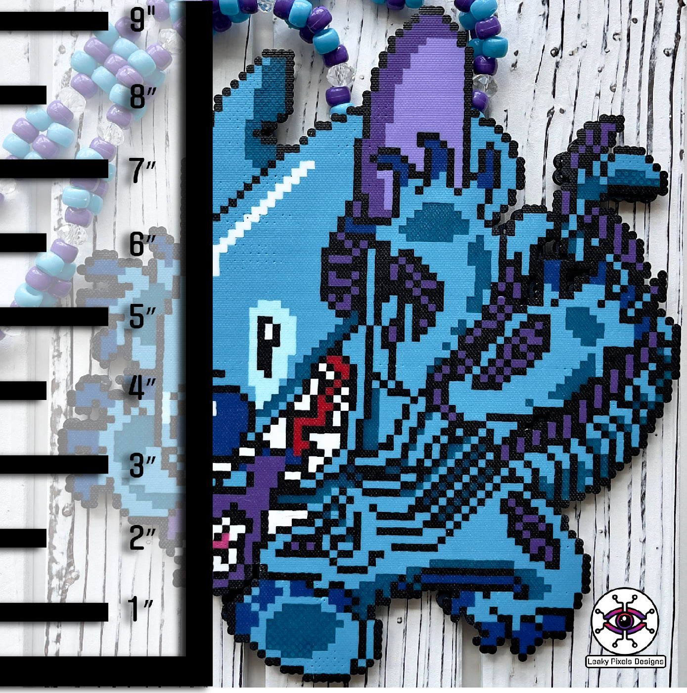 lilo and stitch perler necklace made by leaky pixels. blue and purple stitch/xenomoprh alien.