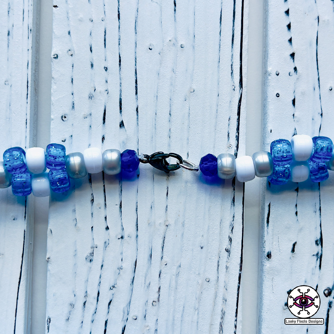 Evil eye perler necklace by leaky pixels. white and  blue with black eye