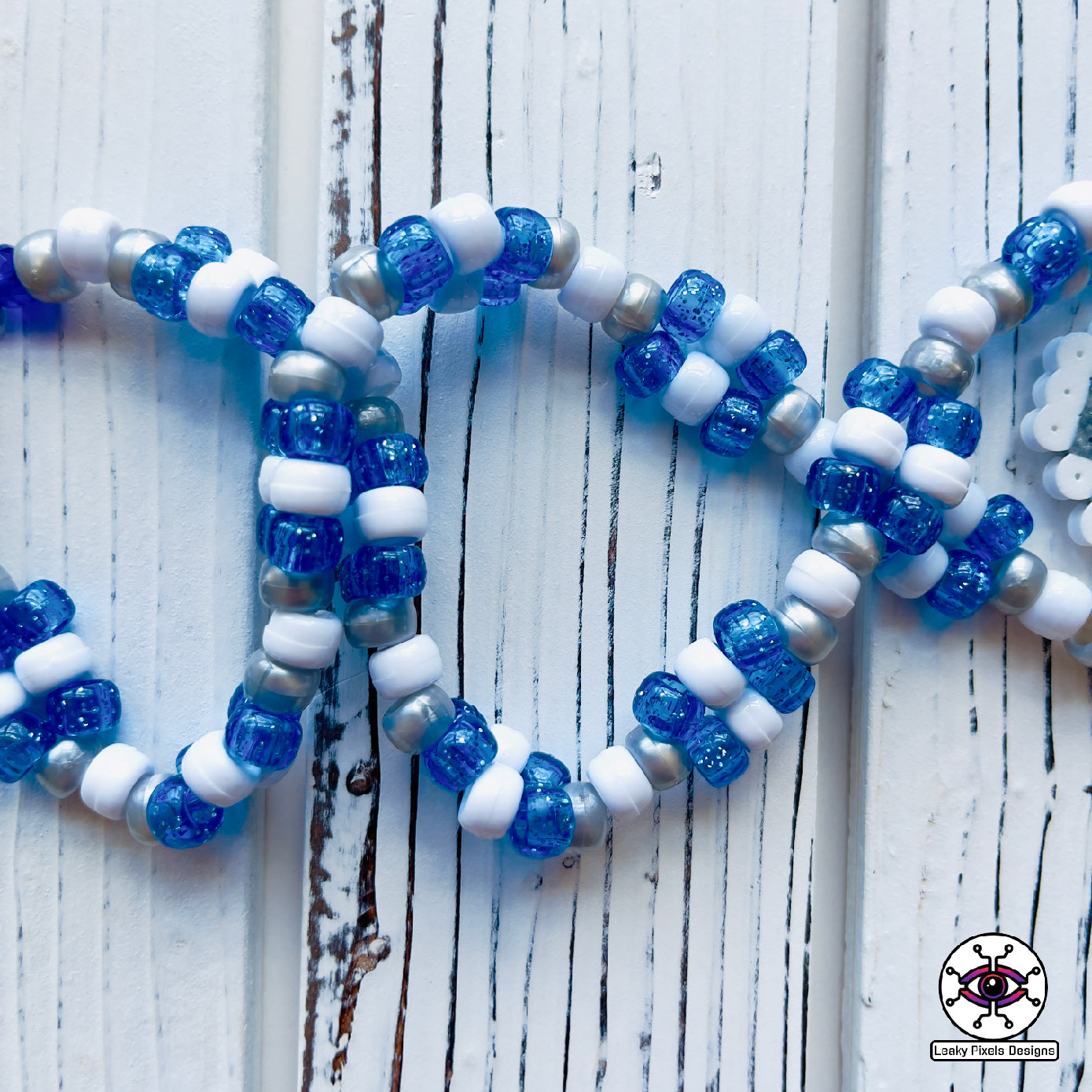 Evil eye perler necklace by leaky pixels. white and  blue with black eye