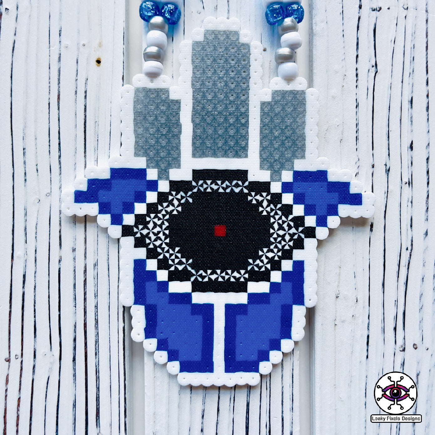 Evil eye perler necklace by leaky pixels. white and  blue with black eye