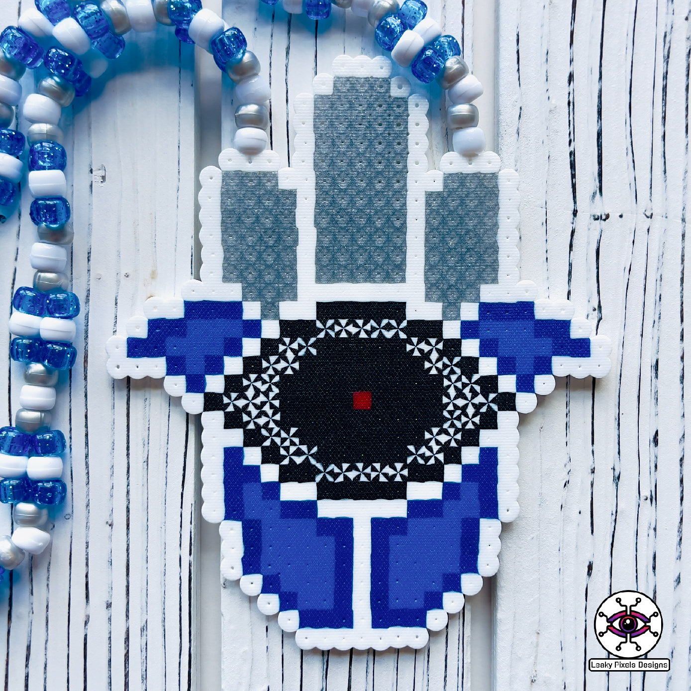 Evil eye perler necklace by leaky pixels. white and  blue with black eye