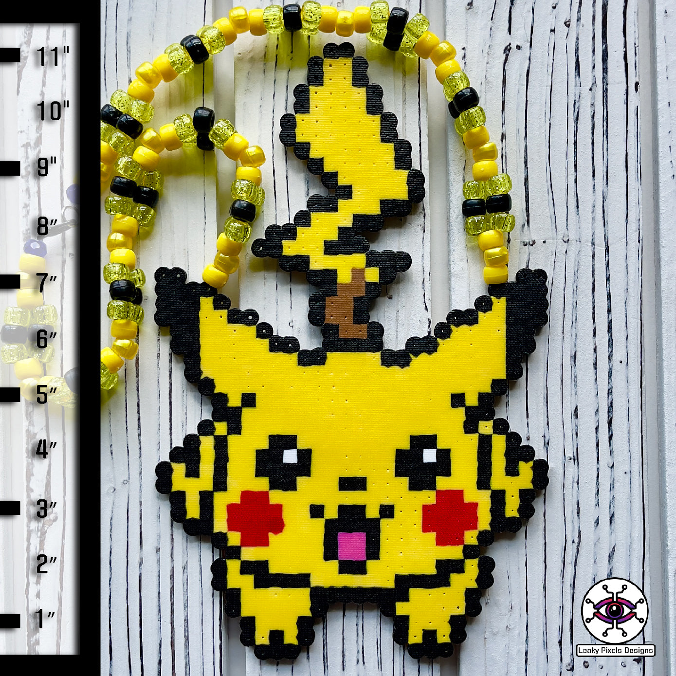 pokemon pikachu yellow perler necklace. Necklace is made of yellow glitter yellow pearl, yellow and black pony beads with a clasp. Pikachu is running with a smile.
