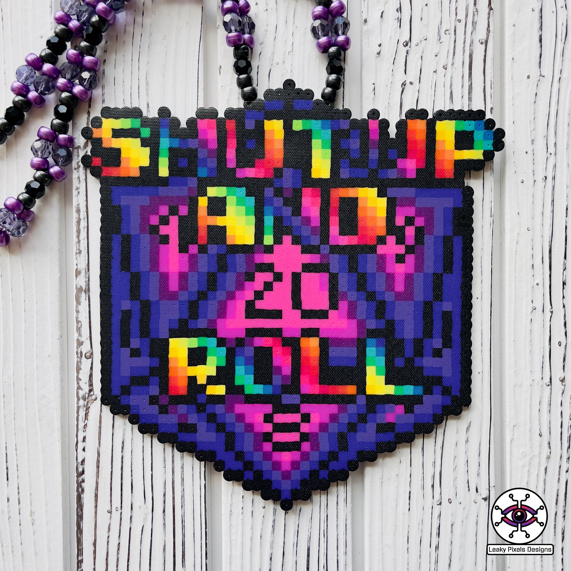 baldurs gate dungeons and dragons d20 dice perler necklace by leaky pixels. says shut up and roll on the front in rainbow letters