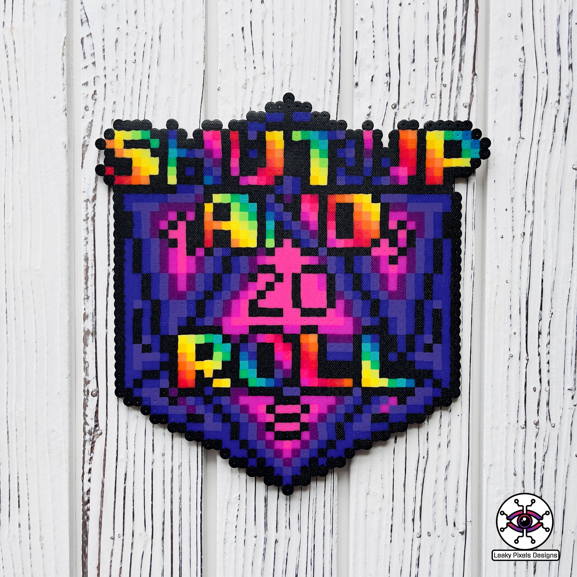 baldurs gate dungeons and dragons d20 dice perler necklace by leaky pixels. says shut up and roll on the front in rainbow letters