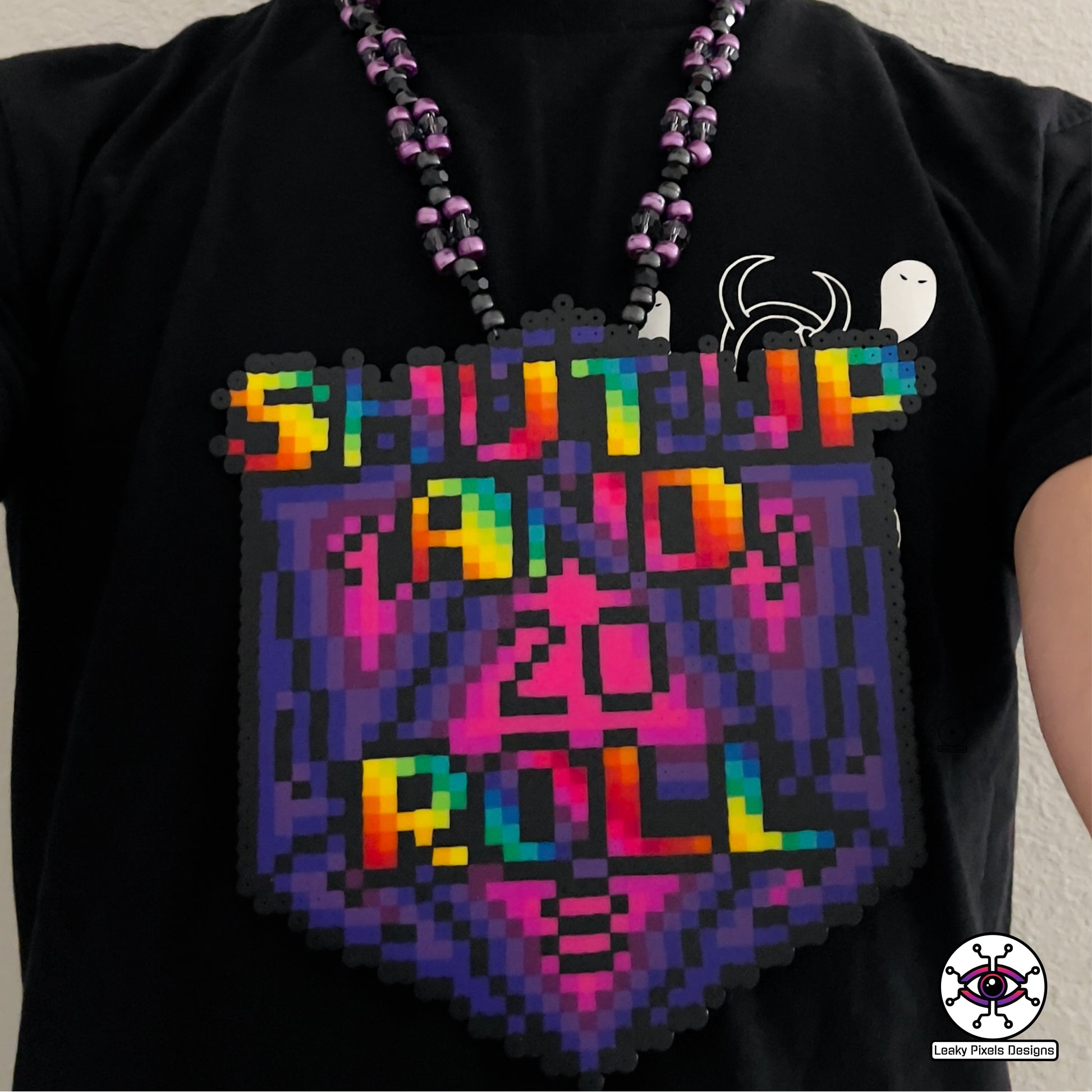 baldurs gate dungeons and dragons d20 dice perler necklace by leaky pixels. says shut up and roll on the front in rainbow letters